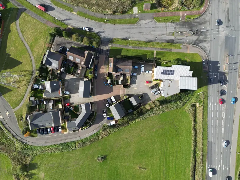 Aerial view of a housing estate on the edge of an English market town, like the estates around Roundway in Devizes