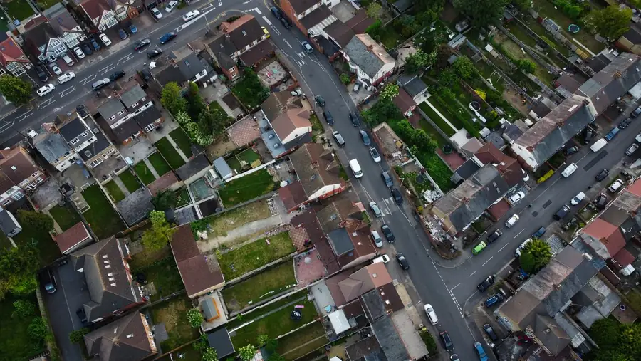 Aerial view of residential streets with cars parked along the kerbs, showing where vehicle crossings meet the road