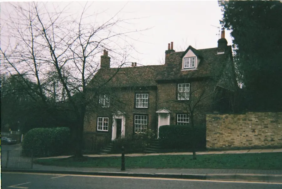 Traditional English brick cottage with a low front boundary and short entrance path