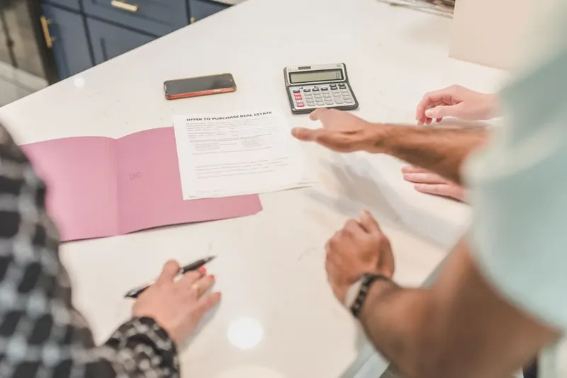 Property documents being reviewed at a desk before starting work on a shared driveway