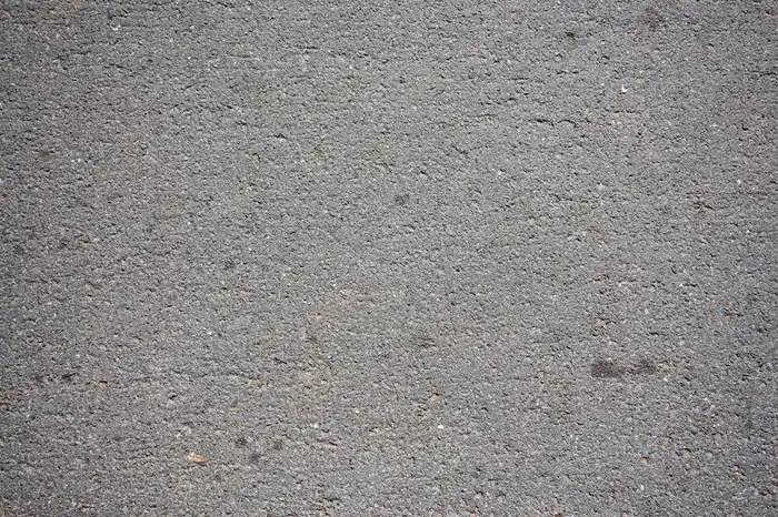 Grey concrete driveway surface outside a home
