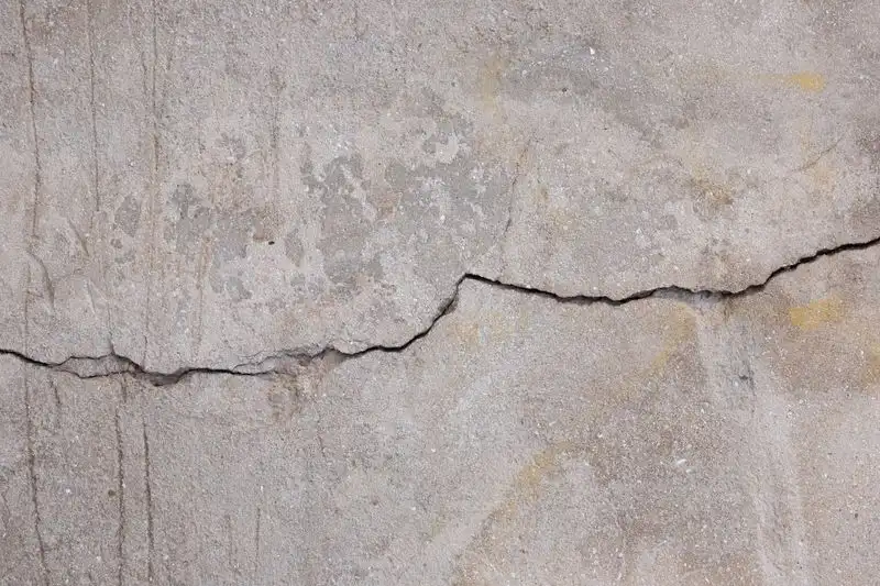 Cracked and damaged driveway surface showing signs of failure