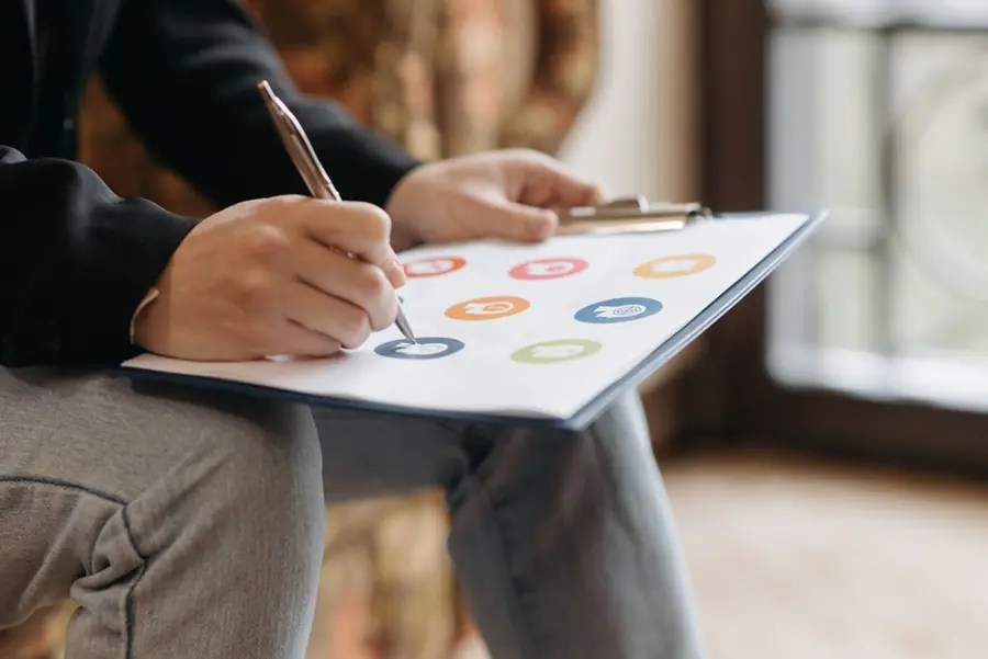 Person working through driveway costs and options on a clipboard