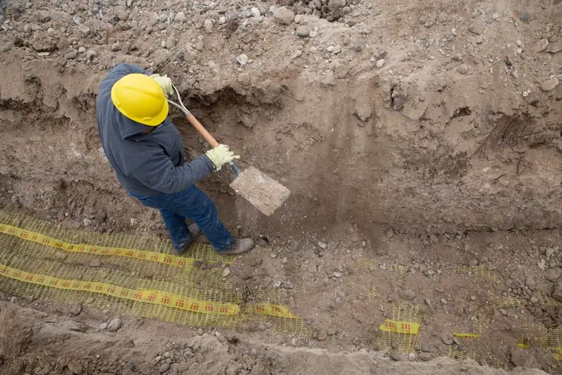 Groundworker digging out to formation level, the excavation stage that a Swindon resin driveway quote should state in millimetres