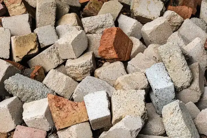 Pile of broken concrete and brick rubble of the kind dug out of a Swindon driveway before resurfacing