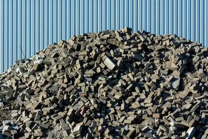 Broken brick and rubble stacked on site awaiting collection during a Swindon driveway replacement