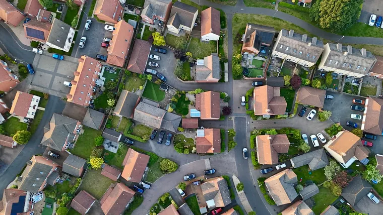 Aerial view of a cul-de-sac of detached and semi-detached houses with driveways and conservatories, typical of the estate housing in Royal Wootton Bassett