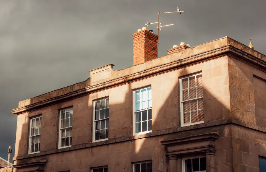 Georgian stone townhouse with sash windows and a parapet, typical of the listed houses in the Devizes conservation area