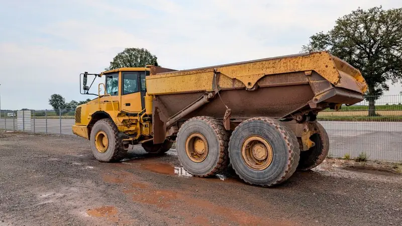 Tipper lorry loading excavated material on site, the usual way driveway spoil leaves a Swindon property