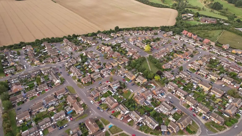 Aerial view of an English housing estate meeting farmland, similar to the eastern edge of Melksham