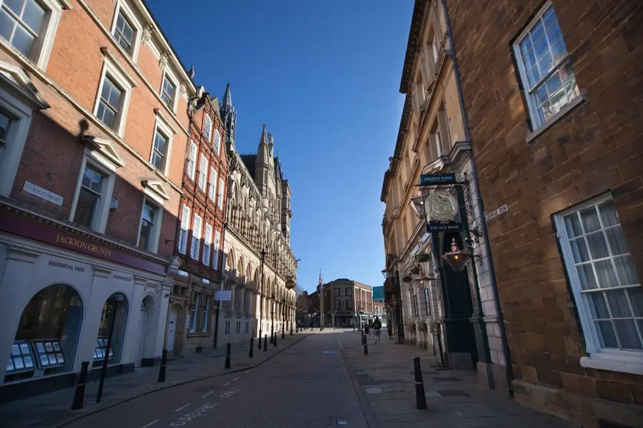 Historic brick and stone buildings lining a town centre street, the kind of listed frontage found in Marlborough's conservation area