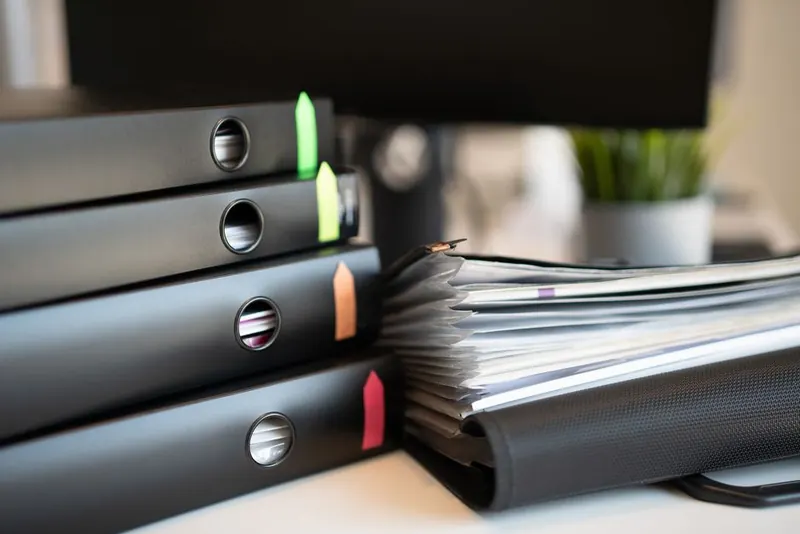 Ring binders of insurance and guarantee documents, the paper trail behind an insurance-backed guarantee