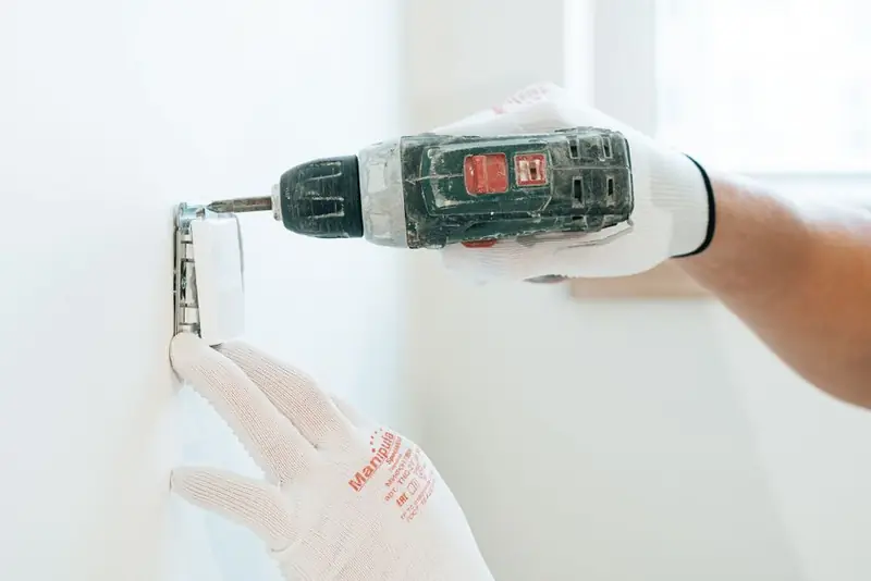 Electrician installing an outdoor power outlet, the kind of work that needs certifying under Part P
