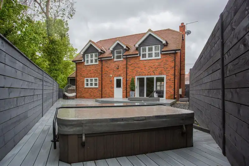 Garden patio area with a hot tub