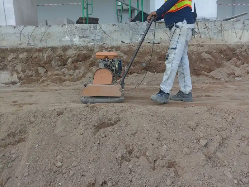 Plate compactor being used on driveway groundwork