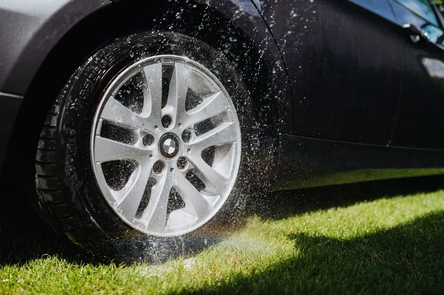 Pressure washing a driveway surface with a wide fan nozzle