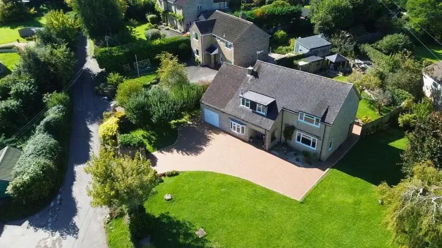 Aerial view of a large buff resin bound driveway at a detached property near Swindon