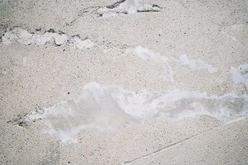 Old driveway surface showing multiple signs of deterioration