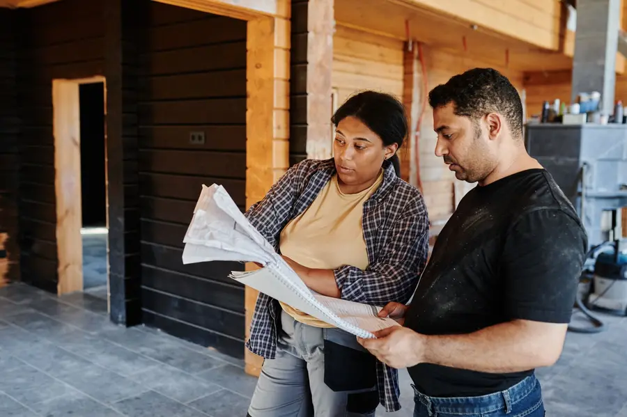 Homeowner going through a checklist before booking a driveway contractor