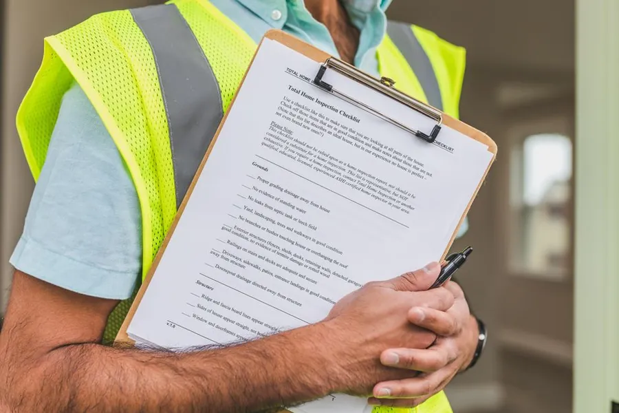 Checklist on a clipboard used to compare resin driveway quotes from Swindon installers line by line