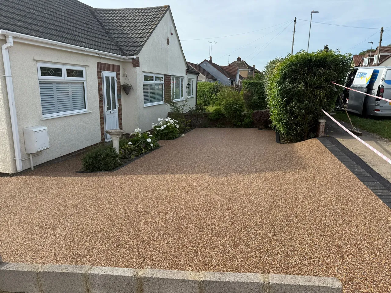 Newly installed buff resin bound driveway outside a bungalow in Swindon