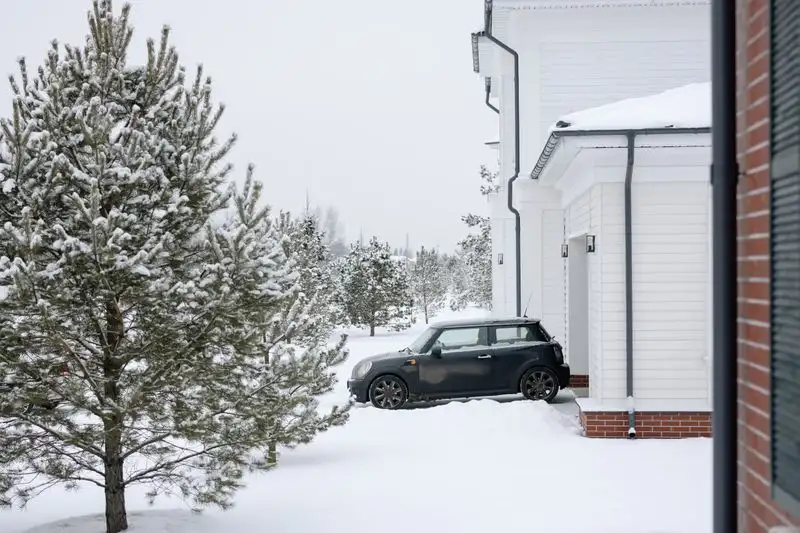 Snow covered driveway outside a home