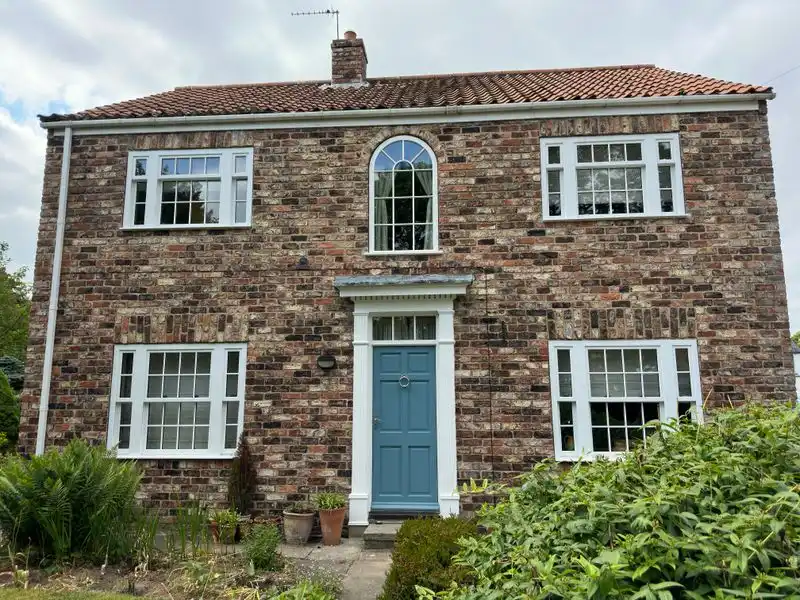 Summer sunshine on a house exterior with driveway