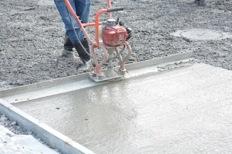 Trowelling a resin bound stone surface by hand