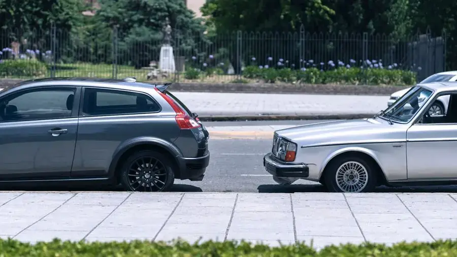 Two cars parked nose to tail along a British residential kerb