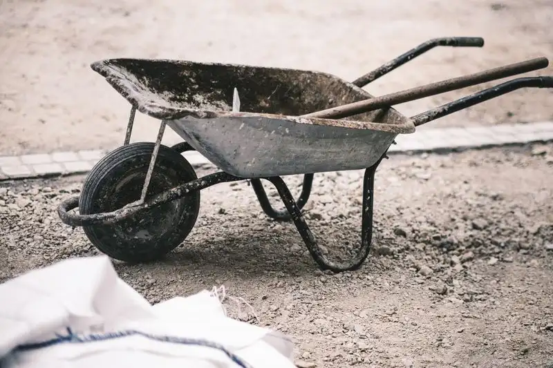 Wheelbarrow and building materials for groundwork
