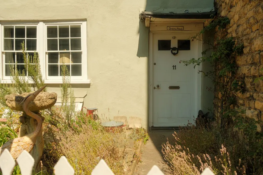 Stone and render cottage frontage with a flagged path, typical of Chippenham's conservation area