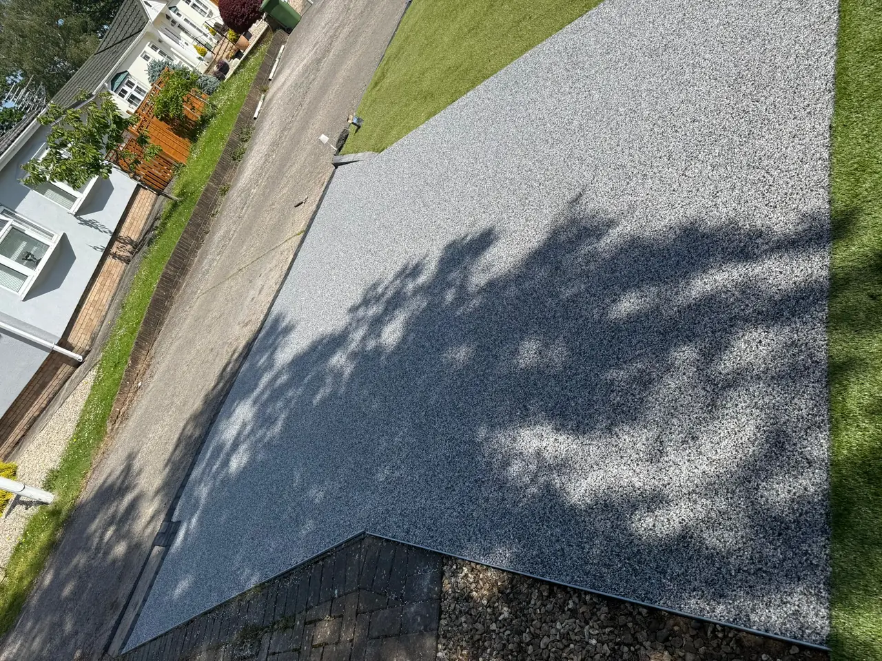 Aerial view of a silver grey resin bound driveway with black border in Swindon